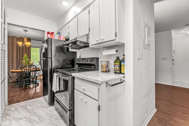 173 Kennedy Dr Unit 173, Bridgeport, CT 06606 - kitchen with black appliances, under cabinet range hood, white cabinetry, a chandelier, and electric panel