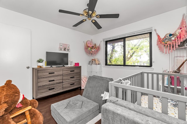 173 Kennedy Dr Unit 173, Bridgeport, CT 06606 - bedroom with dark wood-type flooring, a nursery area, and a ceiling fan