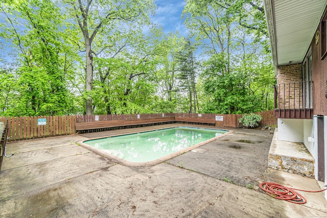 173 Kennedy Dr Unit 173, Bridgeport, CT 06606 - view of pool with a fenced backyard, a patio area, and view of scattered trees