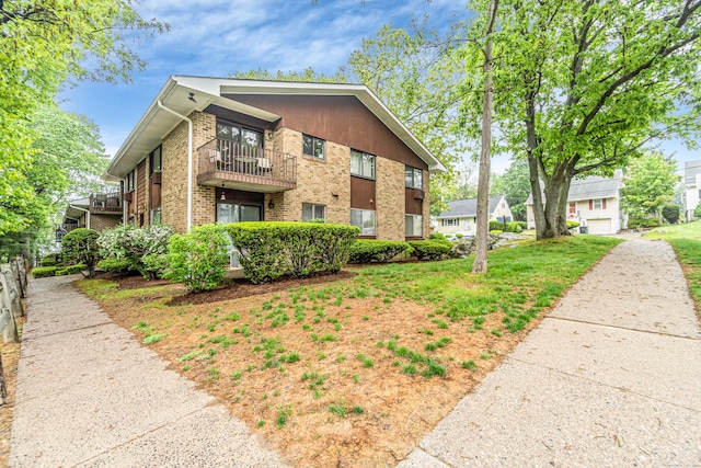 173 Kennedy Dr Unit 173, Bridgeport, CT 06606 - view of side of property featuring a balcony and brick siding