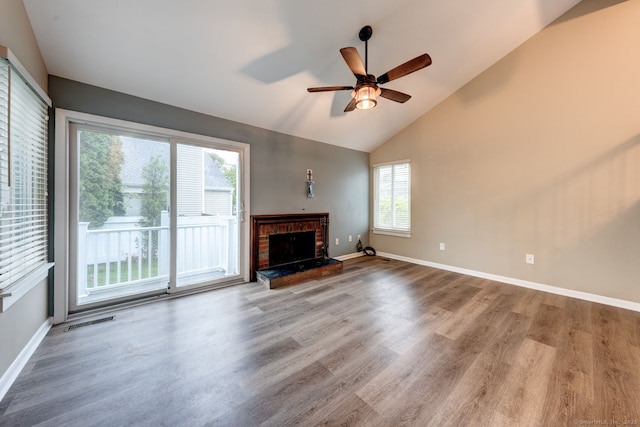 unfurnished living room with ceiling fan, wood finished floors, a fireplace, high vaulted ceiling, and baseboards