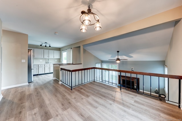 unfurnished living room with light wood-style flooring and a ceiling fan