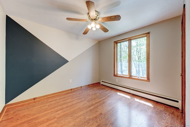 unfurnished room featuring a baseboard heating unit, wood finished floors, ceiling fan, and lofted ceiling