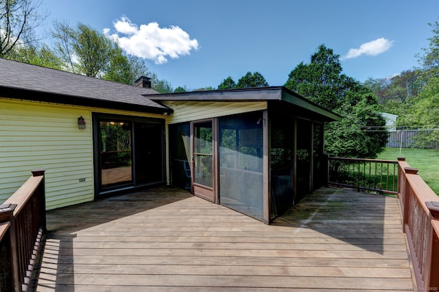 deck with a sunroom and fence