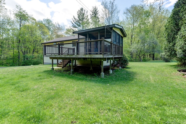 back of property featuring a yard, a deck, a sunroom, and stairway