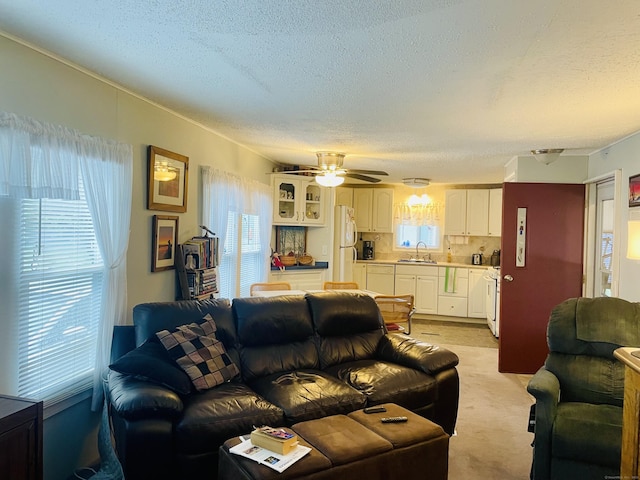 91 Shawnee Rd, East Hartford, CT 06118 - living room with a textured ceiling, light carpet, and a ceiling fan