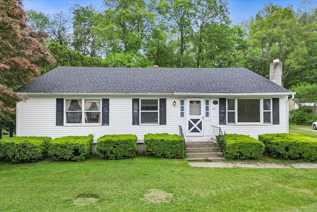 20 Cedar Ln, Norwich, CT 06360 - view of front of house with a chimney, a front lawn, and roof with shingles