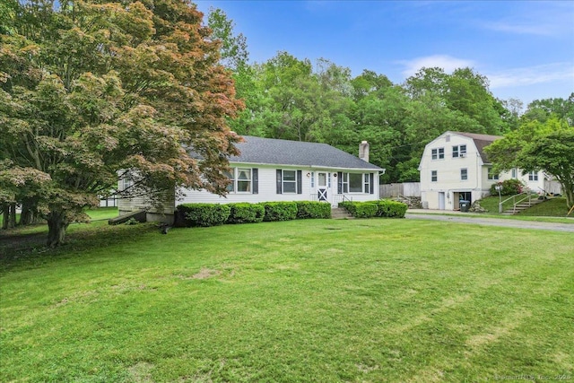 20 Cedar Ln, Norwich, CT 06360 - view of front of house with a chimney, a front lawn, and roof with shingles