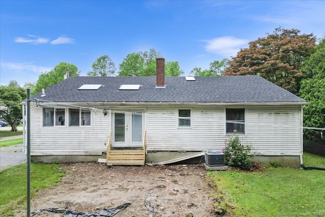 20 Cedar Ln, Norwich, CT 06360 - rear view of property with a chimney, entry steps, cooling unit, french doors, and a lawn