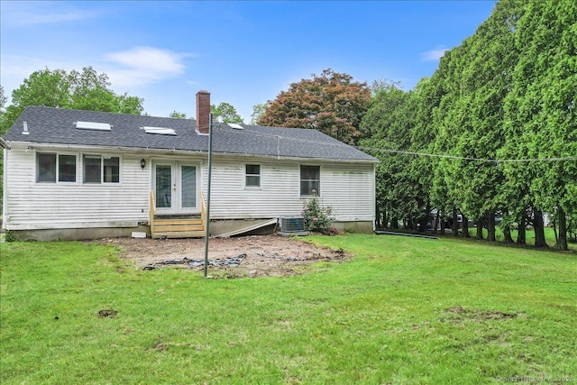20 Cedar Ln, Norwich, CT 06360 - back of property with french doors, a chimney, a yard, entry steps, and central AC unit