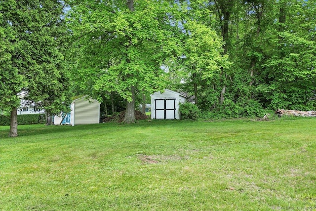 20 Cedar Ln, Norwich, CT 06360 - view of green lawn with a storage shed and an outbuilding