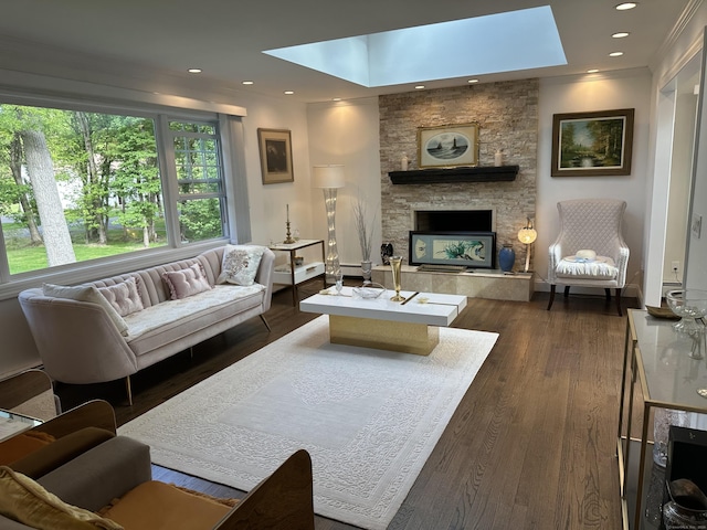 living area featuring a skylight, a fireplace, dark wood finished floors, and recessed lighting