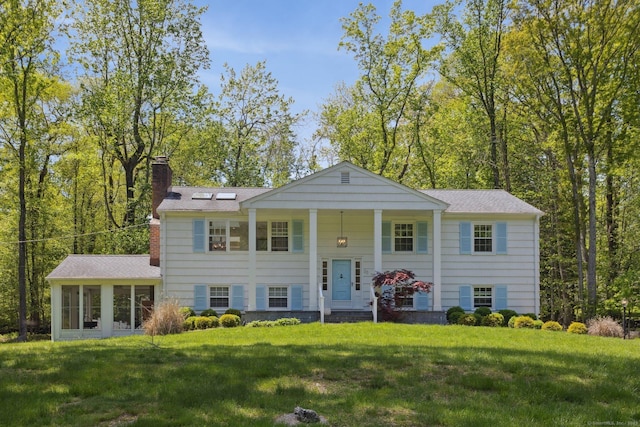 33 Pumpkin Hill Rd, Westport, CT 06880 - raised ranch with a chimney, a front yard, a sunroom, and a shingled roof