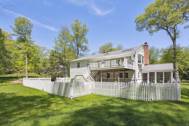 33 Pumpkin Hill Rd, Westport, CT 06880 - back of house with a sunroom, a chimney, stairway, a deck, and solar panels