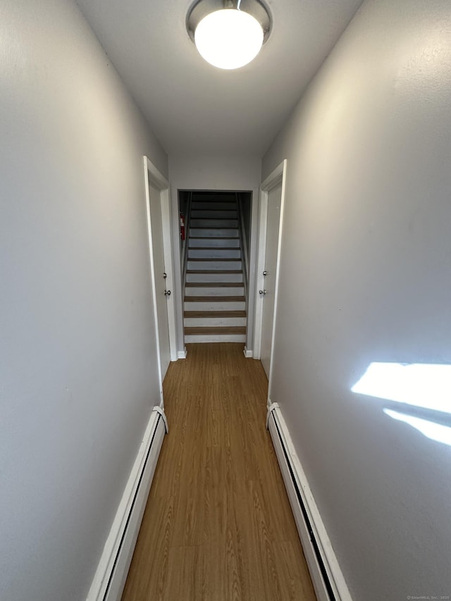 74 Saltonstall Ave, New Haven, CT 06513 - hallway featuring baseboard heating, wood finished floors, stairs, a baseboard heating unit, and baseboards
