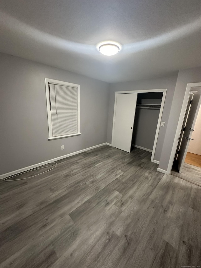 74 Saltonstall Ave, New Haven, CT 06513 - unfurnished bedroom with baseboards, dark wood-style floors, and a closet