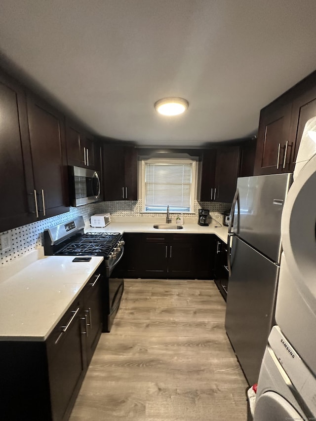 74 Saltonstall Ave, New Haven, CT 06513 - kitchen with stainless steel appliances, a sink, decorative backsplash, light wood-style flooring, and light countertops