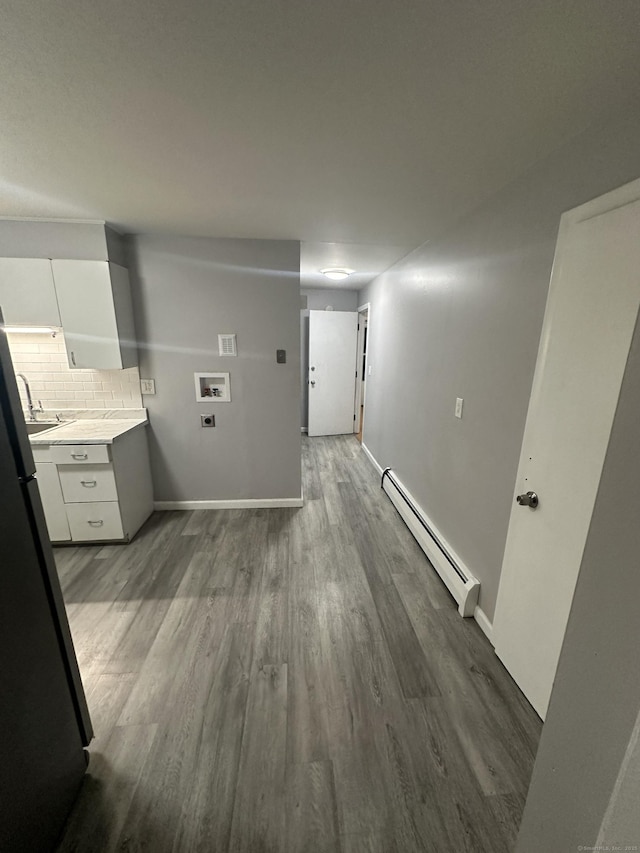 74 Saltonstall Ave, New Haven, CT 06513 - clothes washing area with a baseboard heating unit, wood finished floors, washer hookup, and baseboards