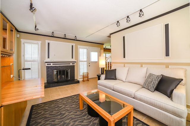85 Viscount Dr Unit 10A, Milford, CT 06460 - living room featuring rail lighting, tile patterned floors, a brick fireplace, stairway, and ornamental molding