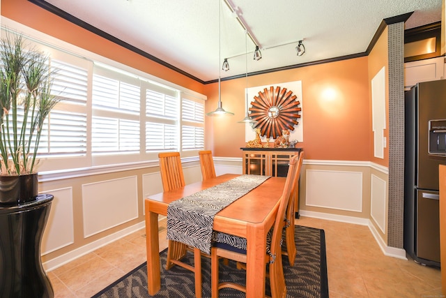 85 Viscount Dr Unit 10A, Milford, CT 06460 - dining space featuring light tile patterned flooring, a decorative wall, crown molding, rail lighting, and wainscoting