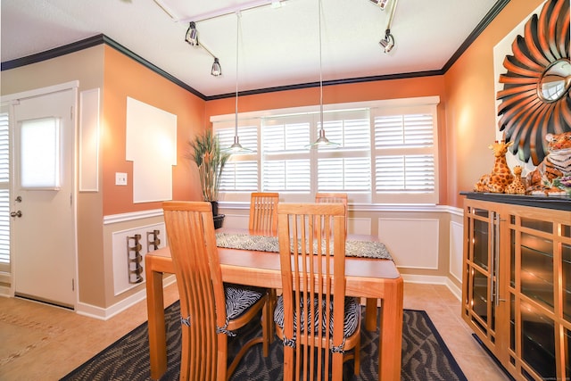 85 Viscount Dr Unit 10A, Milford, CT 06460 - dining area featuring track lighting, ornamental molding, light tile patterned flooring, a wainscoted wall, and a decorative wall