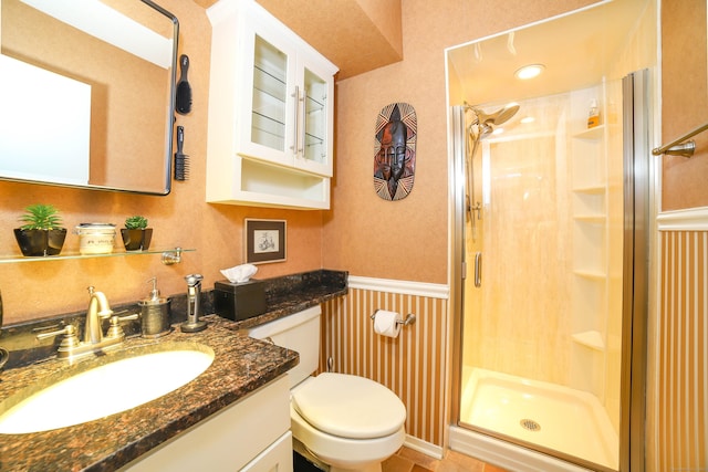 85 Viscount Dr Unit 10A, Milford, CT 06460 - bathroom featuring a stall shower, vanity, a wainscoted wall, and toilet