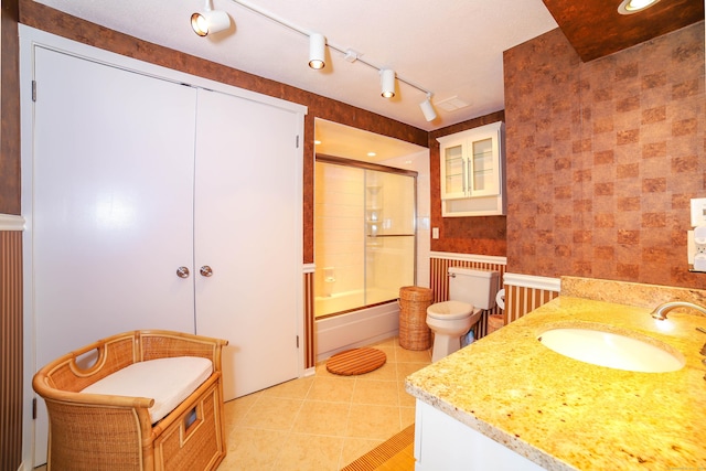 85 Viscount Dr Unit 10A, Milford, CT 06460 - full bathroom with toilet, tile patterned flooring, vanity, and combined bath / shower with glass door