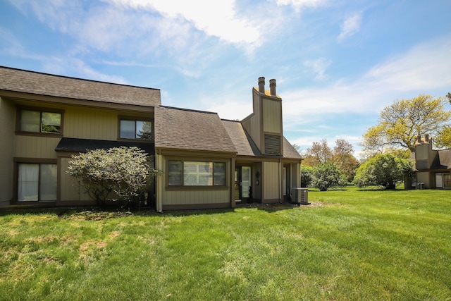 85 Viscount Dr Unit 10A, Milford, CT 06460 - rear view of property with central AC, a yard, and a chimney