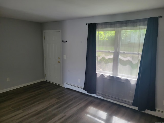 spare room with wood finished floors and baseboards