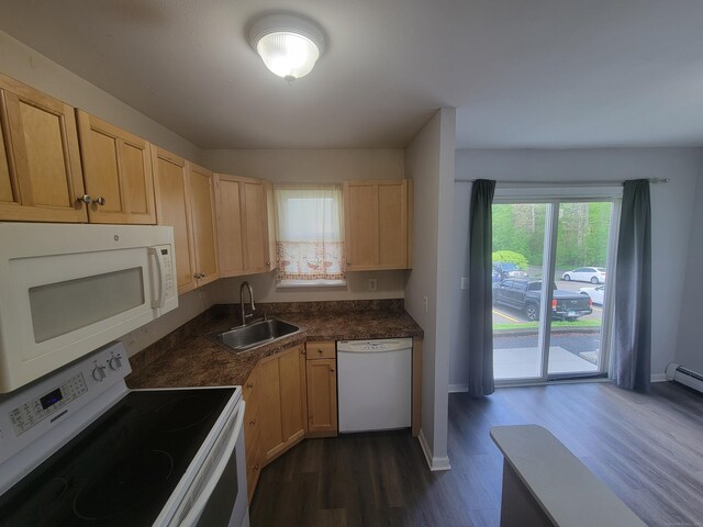 kitchen featuring white appliances, a sink, light brown cabinetry, and dark wood finished floors