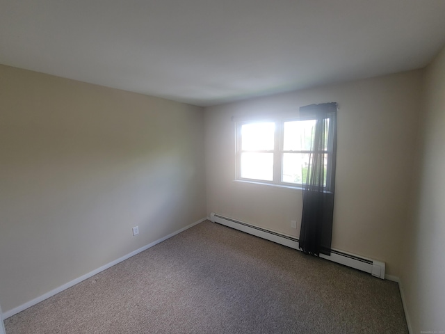 carpeted empty room featuring a baseboard radiator and baseboards
