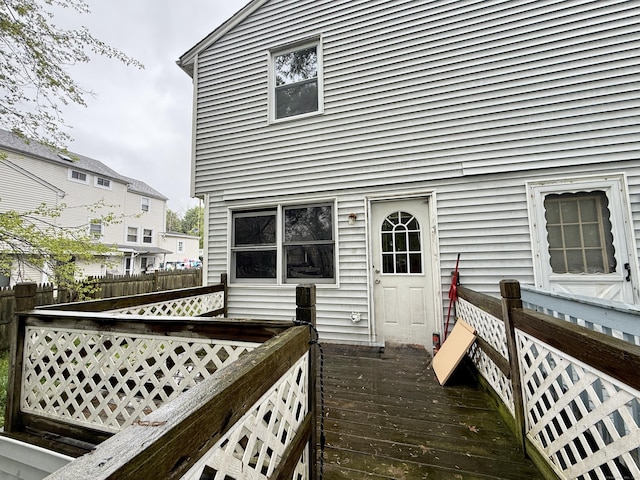 back of house featuring a deck and fence
