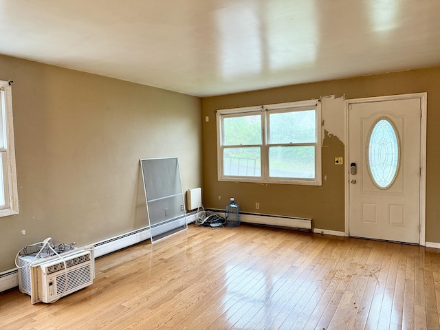 entrance foyer featuring wood-type flooring, a baseboard heating unit, and baseboards