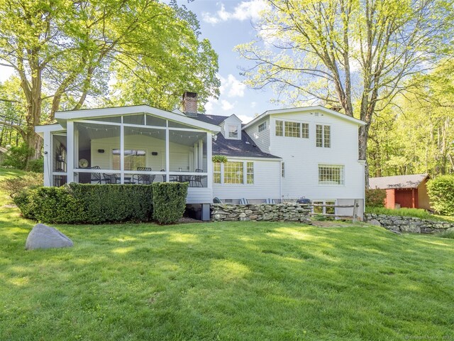 61 Nod Hill Rd, Wilton, CT 06897 - back of property featuring a chimney, a lawn, and a sunroom