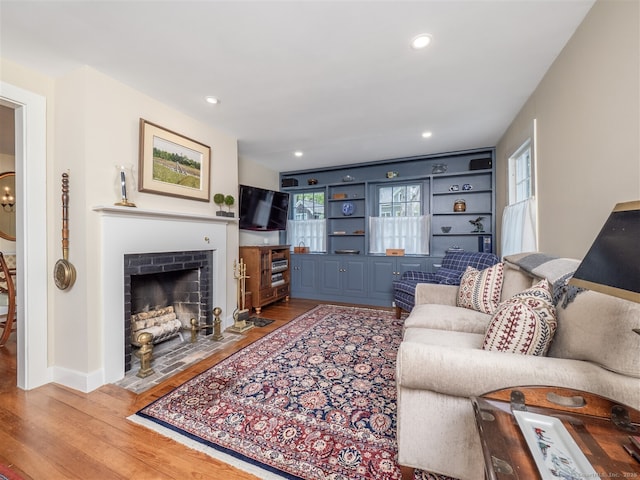 61 Nod Hill Rd, Wilton, CT 06897 - living area with wood finished floors, a fireplace with flush hearth, recessed lighting, and baseboards