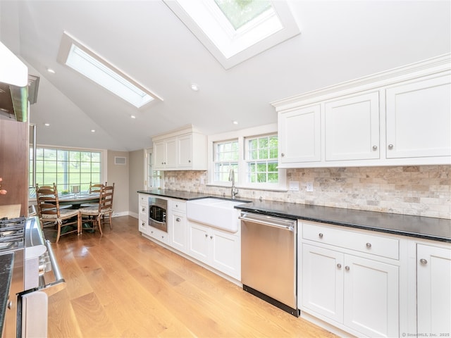 61 Nod Hill Rd, Wilton, CT 06897 - kitchen with a skylight, appliances with stainless steel finishes, a sink, light wood-style floors, and lofted ceiling