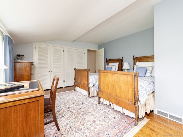61 Nod Hill Rd, Wilton, CT 06897 - bedroom with vaulted ceiling, light wood-style floors, and two closets