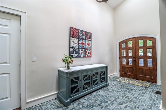 foyer featuring a towering ceiling