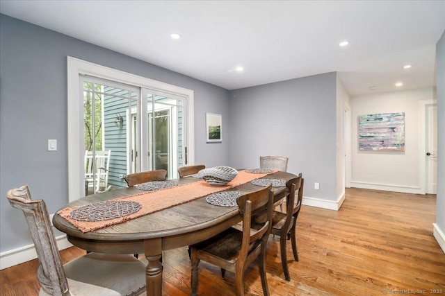 dining area featuring light wood-style floors, recessed lighting, baseboards, and a baseboard heating unit