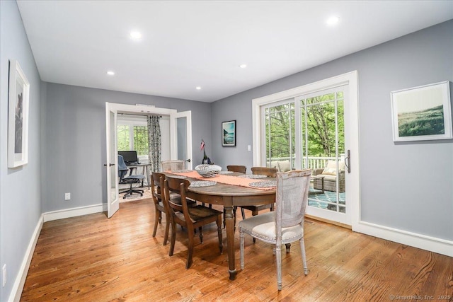 dining room featuring light wood-type flooring, baseboards, and recessed lighting