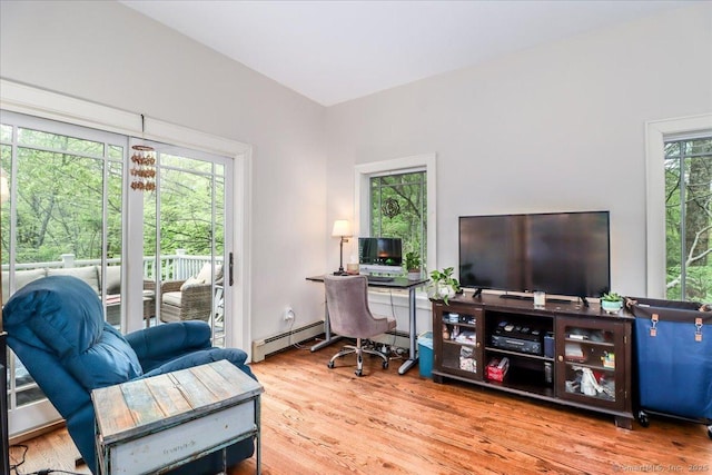 office area featuring baseboard heating and wood finished floors