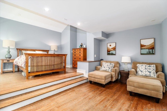 bedroom with wood finished floors and recessed lighting