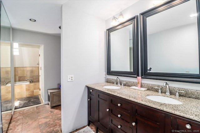 bathroom featuring double vanity, baseboards, and stone finish floors