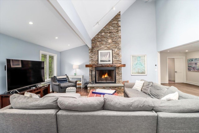 living room featuring wood finished floors, a fireplace, high vaulted ceiling, baseboards, and recessed lighting