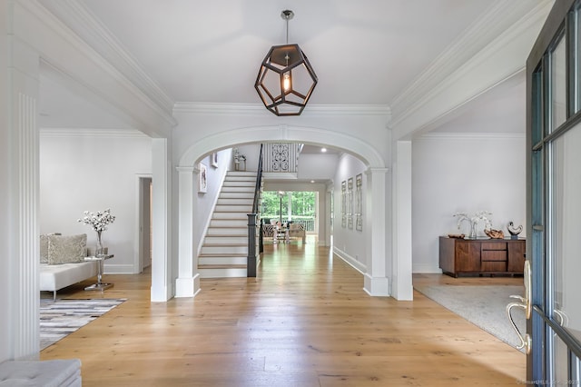6 Spectacle Ln, Ridgefield, CT 06877 - entryway with arched walkways, stairway, wood finished floors, baseboards, and crown molding