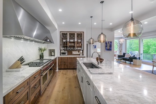 6 Spectacle Ln, Ridgefield, CT 06877 - kitchen featuring wall chimney range hood, a sink, double oven range, tasteful backsplash, and recessed lighting