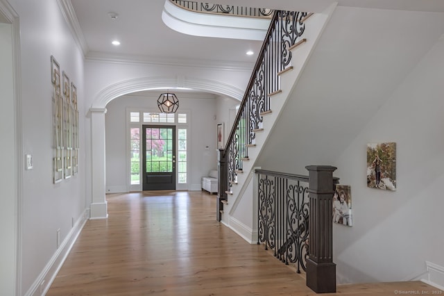 6 Spectacle Ln, Ridgefield, CT 06877 - entryway featuring arched walkways, ornamental molding, wood finished floors, baseboards, and recessed lighting