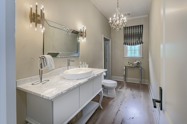 6 Spectacle Ln, Ridgefield, CT 06877 - bathroom featuring a chandelier, toilet, ornamental molding, wood finished floors, and vanity