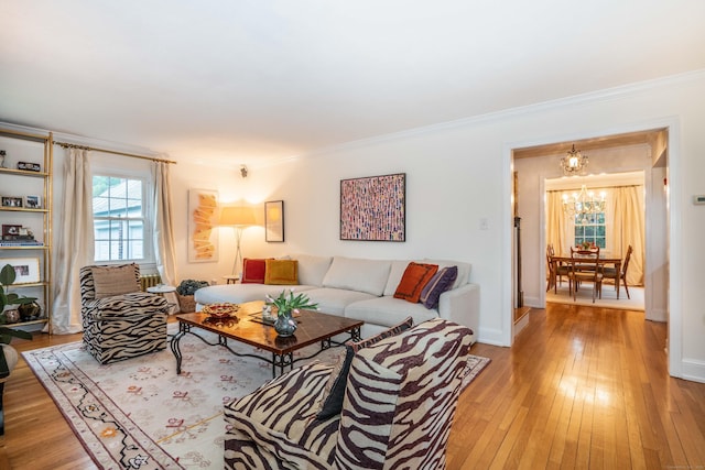 341 Quaker Ln N, West Hartford, CT 06119 - living area with a chandelier, light wood finished floors, ornamental molding, and baseboards