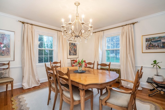 341 Quaker Ln N, West Hartford, CT 06119 - dining area featuring a chandelier, light wood-style floors, baseboards, ornamental molding, and healthy amount of natural light